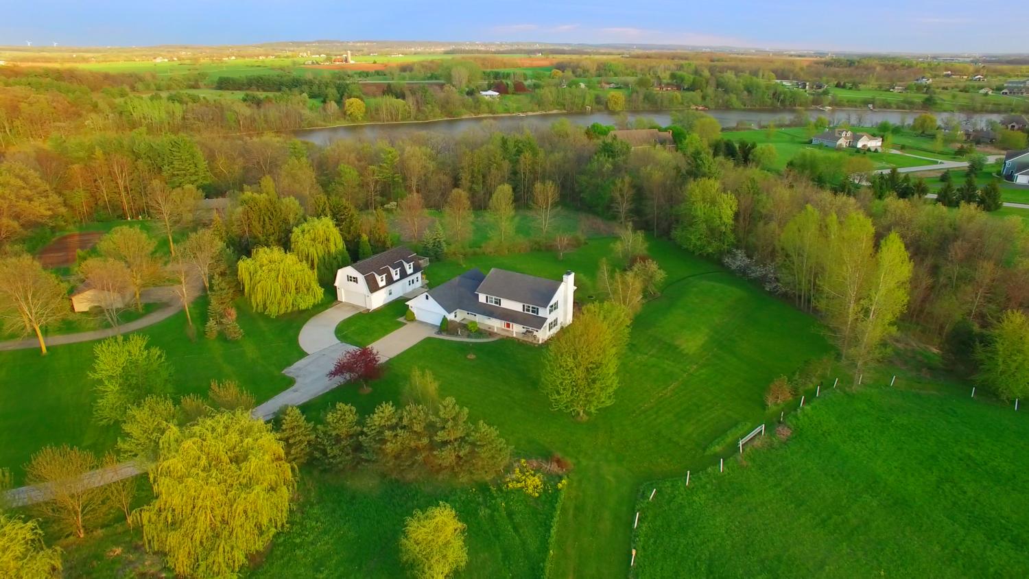 Aerial photo of white house on large plot of land