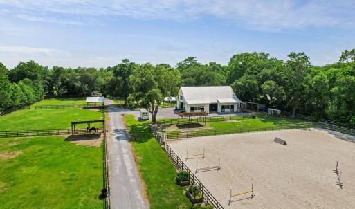 Aerial: paddocks, barn, and arena