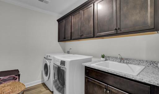 49. Upstairs laundry room with sink and