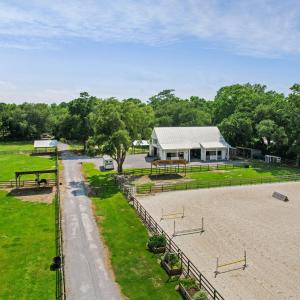 Aerial: paddocks, barn, and arena